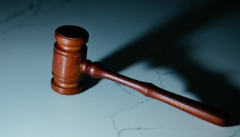 a wooden judge's gavel sitting on top of a table
